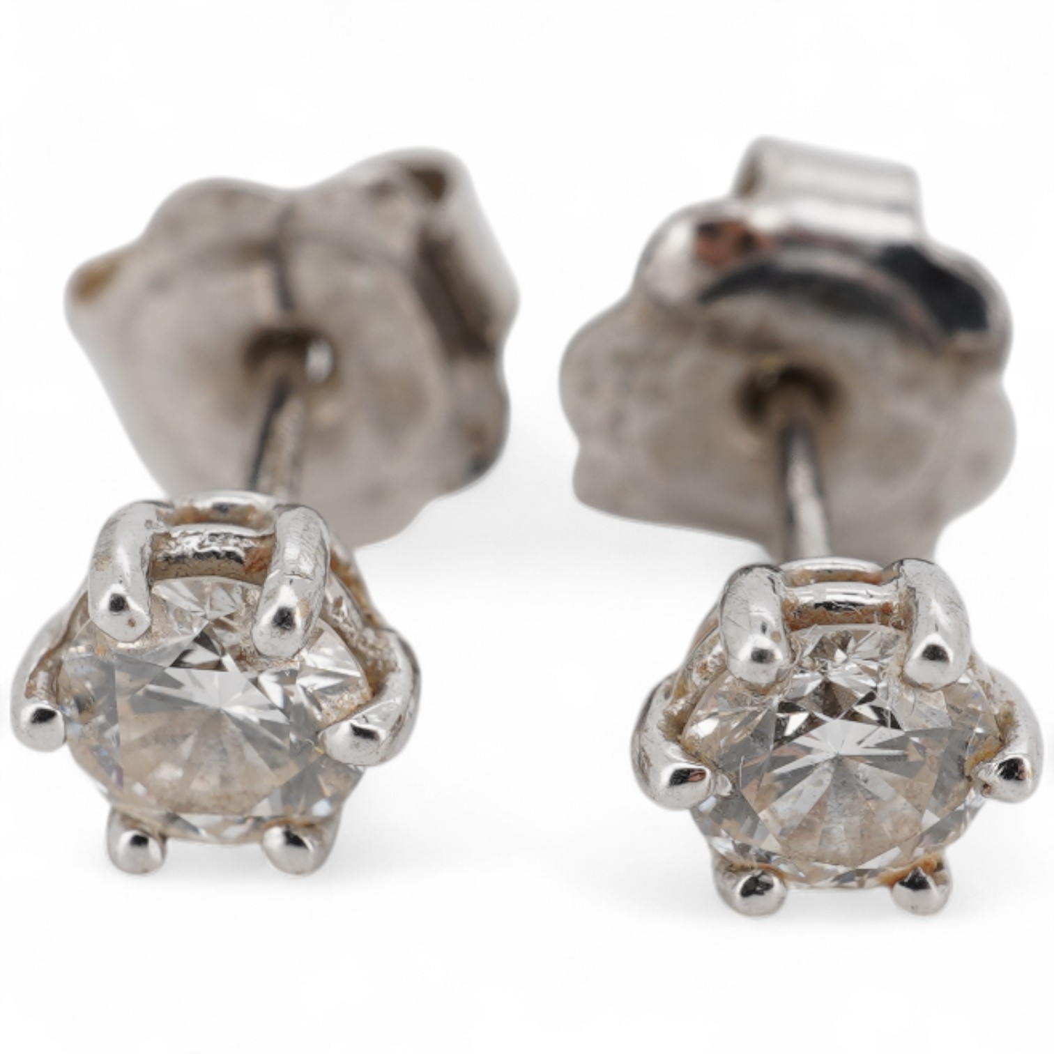 A pair of 18ct white gold and solitaire diamond set ear studs, each stone weighing approximately 0.15ct, gross weight 1.3 grams.